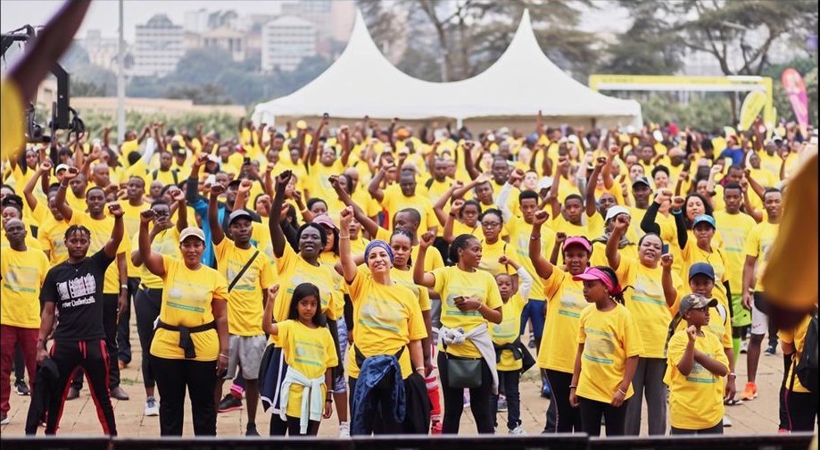 Crowd of Step for Safety participants wearing yellow shirts